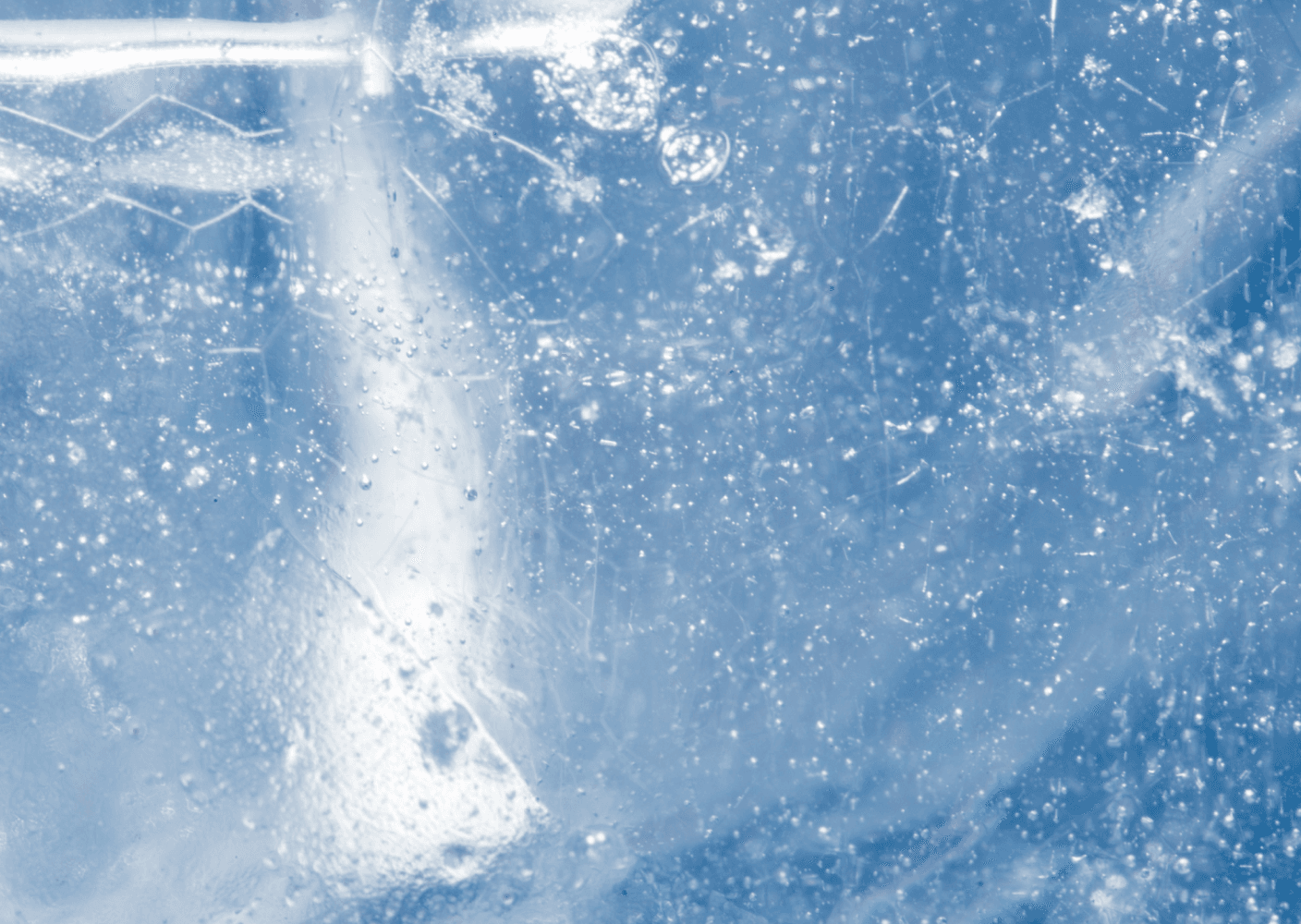 A close-up photo of textured ice with air bubbles and cracks, showcasing its intricate details.