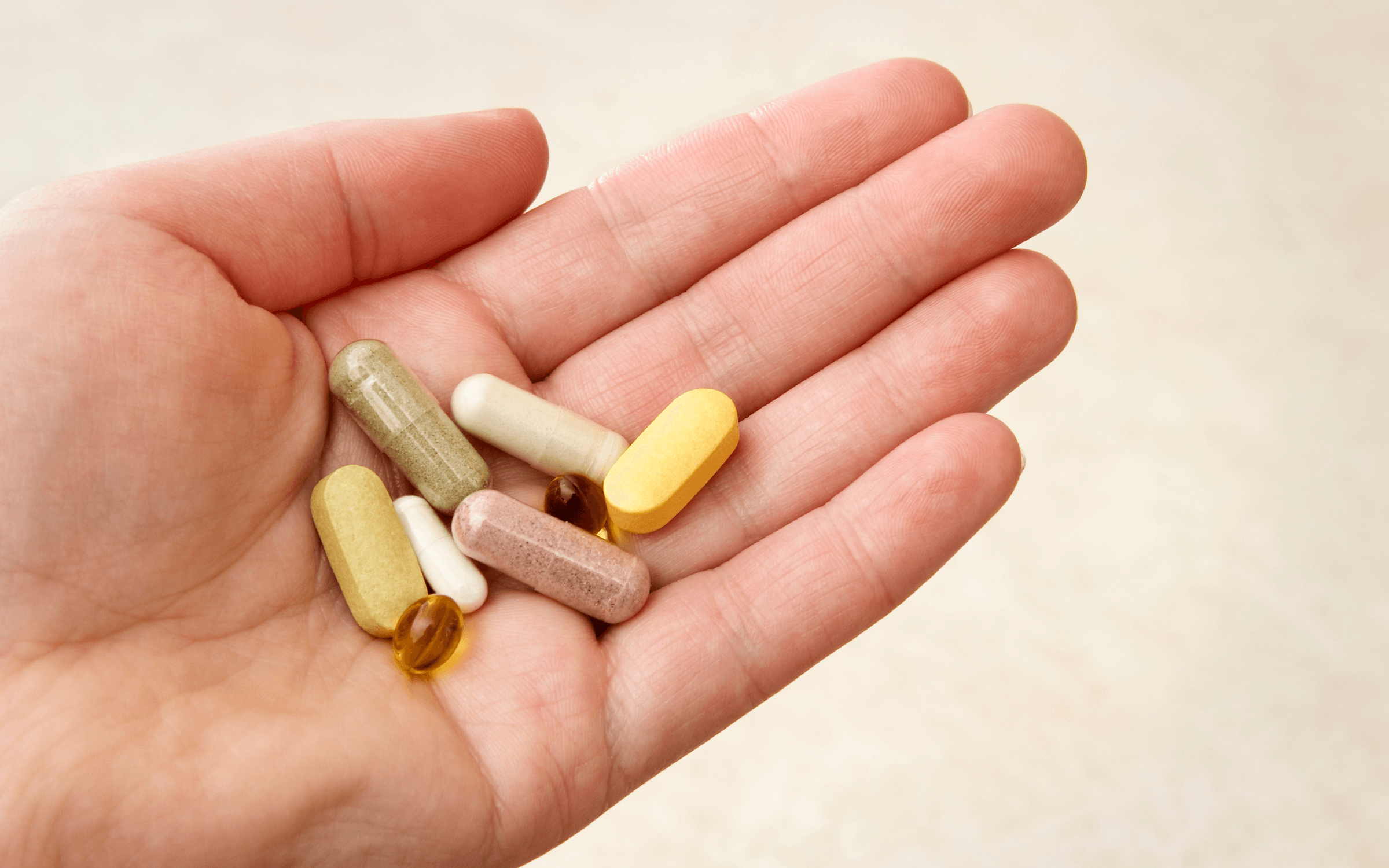 Photo of a hand holding supplements