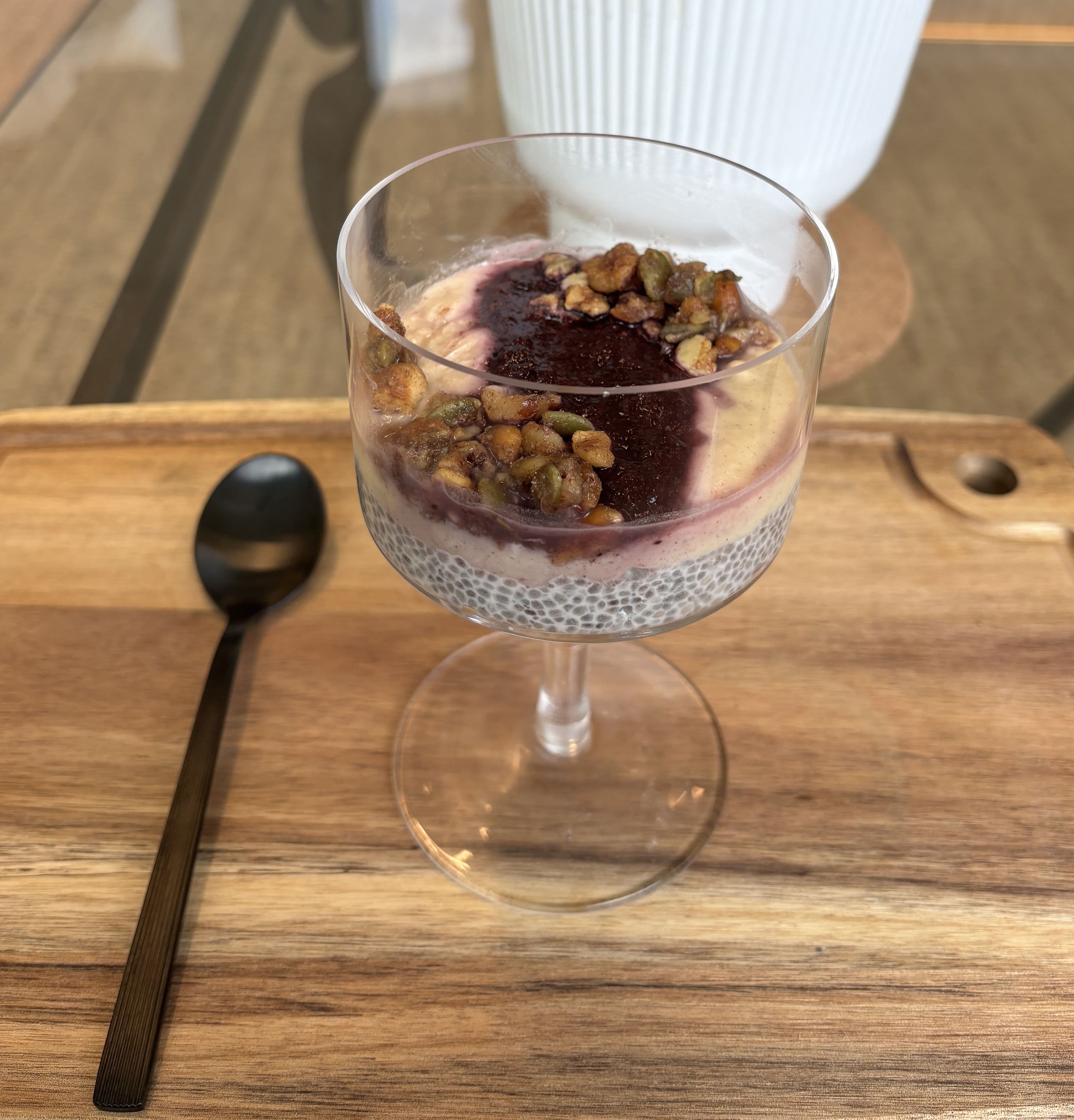 a chia pudding parfait placed on a wooden board