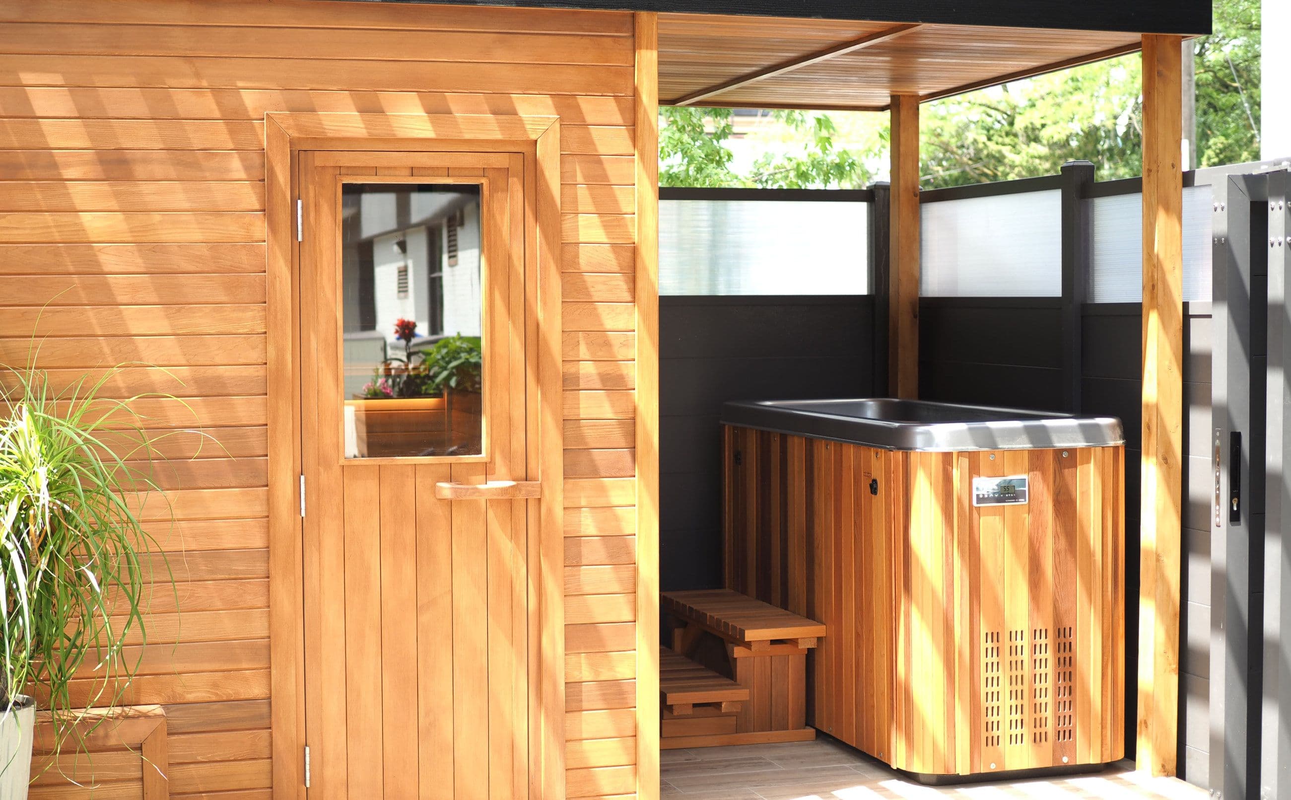 The outdoor sauna and cold plunge tub beneath a wooden canopy at the Recovery Sanctuary.
